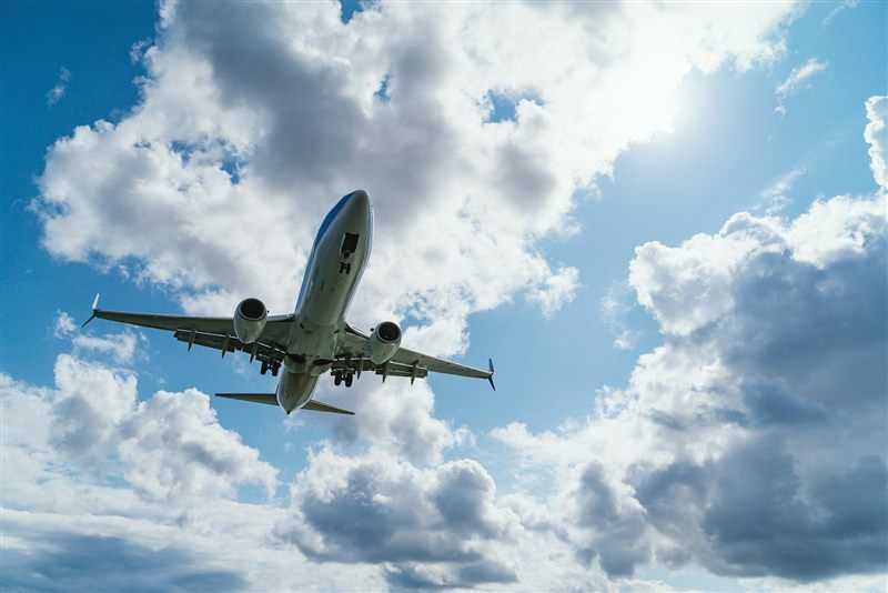 Commercial cargo aircraft being loaded on airport tarmac